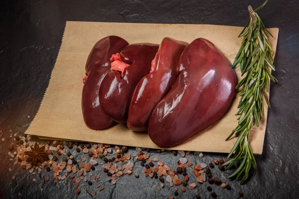 Top view on group of raw pork kidneys served on craft paper — Stock Image Top view on group of raw pork kidneys served on craft paper Royalty Free Stock Photos