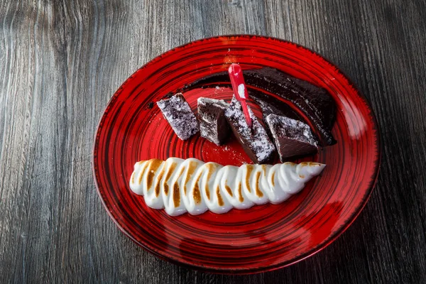 Sabroso pastel de brownie casero en rodajas con crema blanca al horno —  Fotos de Stock