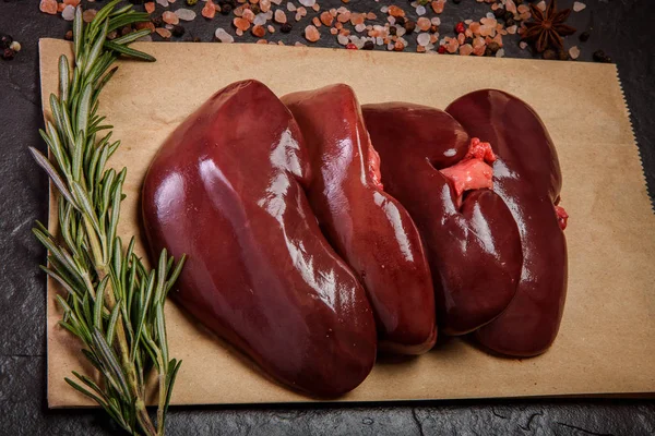 Top view closeup group of raw pork kidneys with rosemary — Stock Image Top view closeup group of raw pork kidneys with rosemary Stock Photo