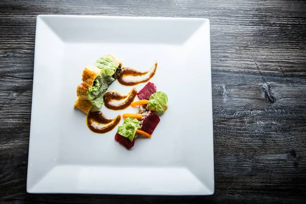 Top view on delicious dish of baked in dough meat with salad and sauce — Stock Photo, Image