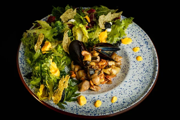 top view on restaurant appetizer of assorted seafood and salad leaves