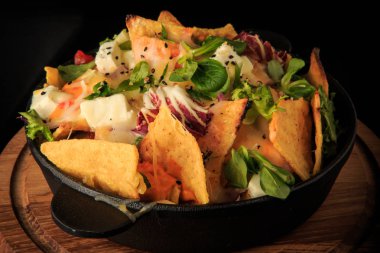 closeup ince dekore peynir ve yeşillik salatası siyah üzerinde