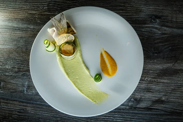 beyaz çanak üzerinde garnitür ile zarif dekore edilmiş balık rulo üst görünümü