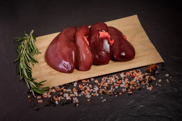 Top view on group of raw pork kidneys with rosemary — Stock Image Top view on group of raw pork kidneys with rosemary Stock Image