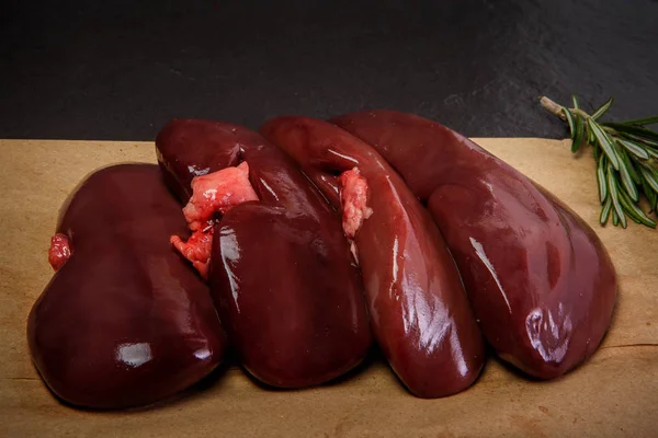 Closeup group of raw pork kidneys served with rosemary — Stock Image Closeup group of raw pork kidneys served with rosemary Stock Image