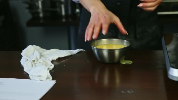 Closeup female hands take away small metal bowl with whipped egg yolks with sugar — Stock Video