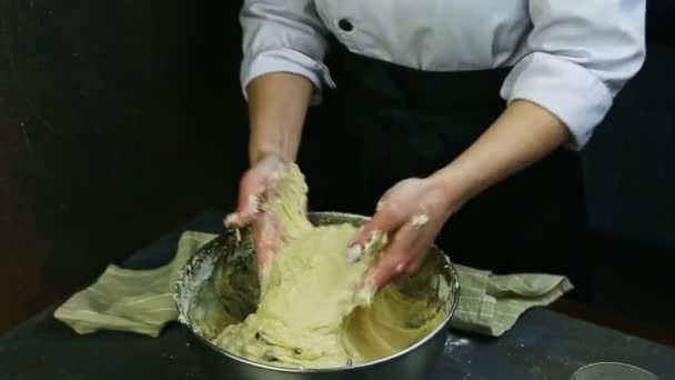 Şekerlemecinin elleri büyük metal kasede kuru üzümlerle çabucak hamur yoğurur. — Stok video