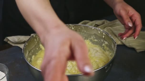 Close-up vrouw handen langzaam mengen door lepel zachte gist deeg in diepe metalen kom — Stockvideo