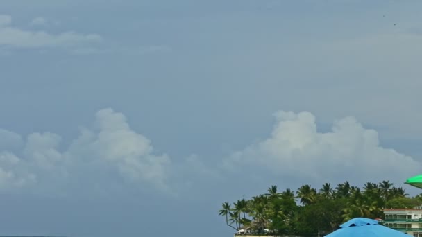 Büyük kabarık beyaz bulutların üzerindeki panorama sakin mavi okyanusun üzerinde süzülür. — Stok video
