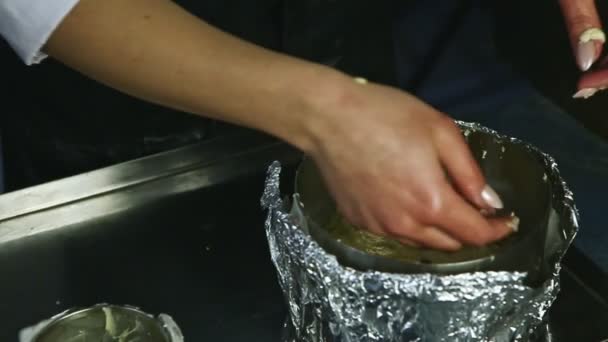 Slow motion closeup woman hands tamp part of soft yeast dough into baking form — Stock Video