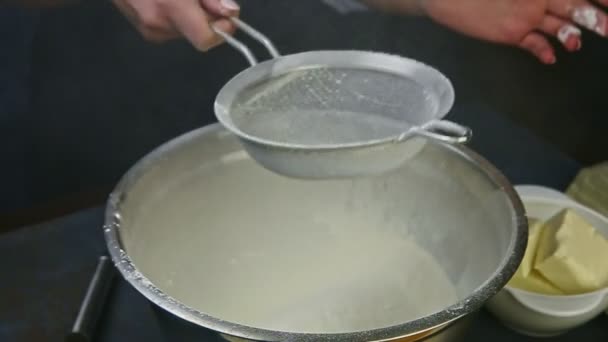 Slow motion closeup woman hands hold empty sieve above bowl with sifted flour — Stock Video