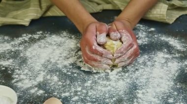 Ağır çekimde kadın eli küçük bir maya hamurundan top oluşturur.