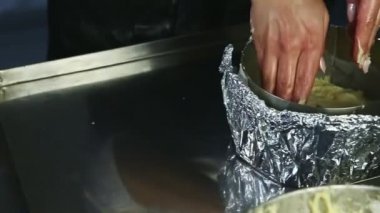 Kadın ellerine yakın çekim panoraması. Yumuşak maya hamurunun bir kısmını pişirme şekline sokun.
