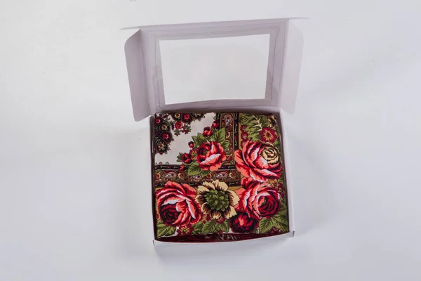 薄緑色の背景にフラットレイスタイルで設計された赤いバラの花の装飾と柔らかい綿のスカーフと小さな白いギフトボックス上のトップビュー — ストック写真