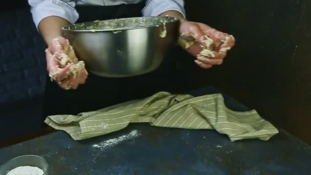 Slow motion vrouw in chef-kok uniform neemt weg grote metalen kom met deeg — Stockvideo