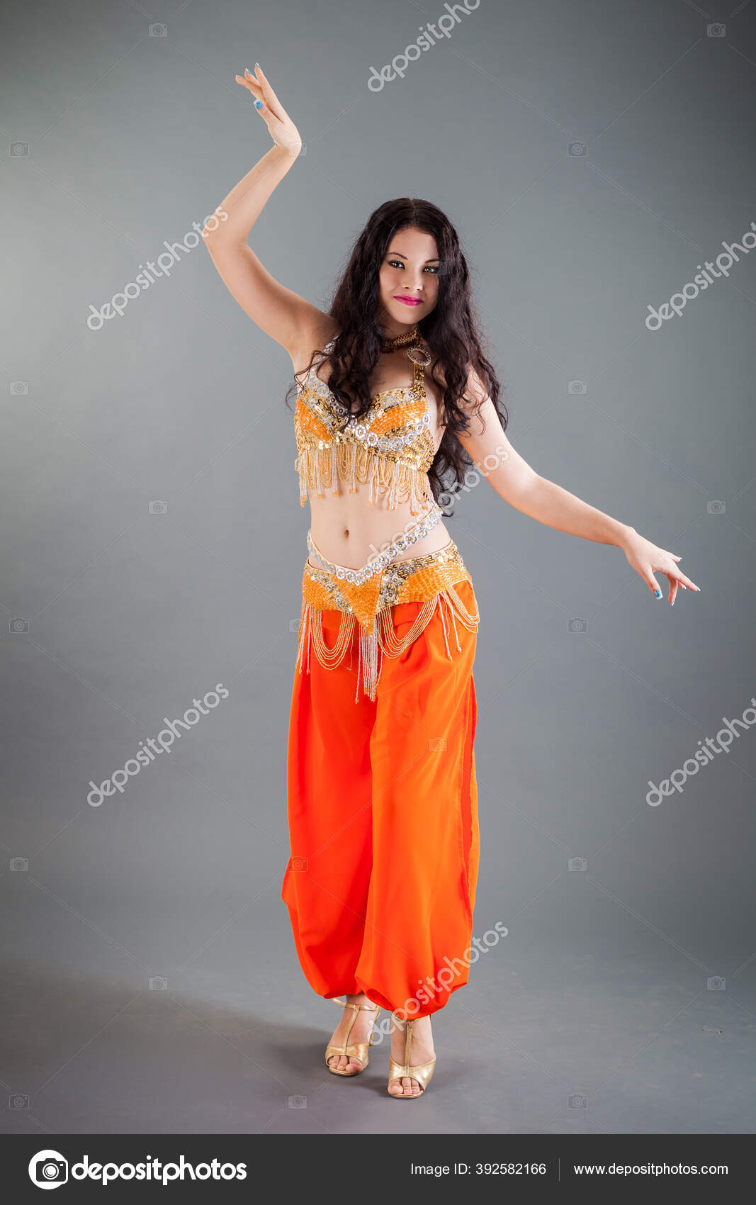 _TaseAnxa_07: Belly dancer with dark blue hair, in copper dress with bright  red and orange metallic highlights, lace satin silky flowing flamenco  outfit like clouds and smoke, wild windy hair, perfect body