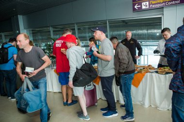 Birçok yolcu Lviv havaalanı salonundaki bedava dezenfekte masasından atıştırmalık ve içecek almayı dener.