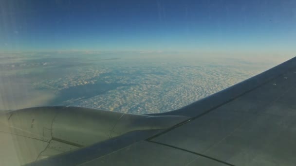 Légi felvétel a repülőgép ablakából nagy repülőgép szárny felett repülnek bolyhos fehér felhők — Stock videók