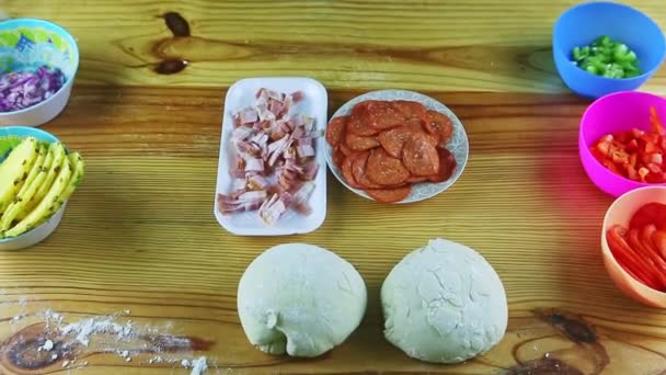 Top view on different raw ingredients for making pizza served on wooden table — Stock Video