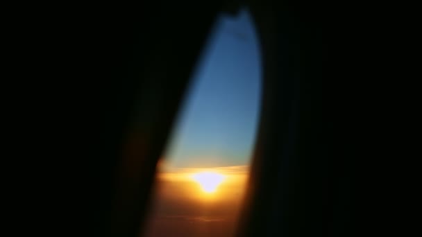 Aerial view from aircraft window across steel wing silhouette at beautiful sunset — Stock Video