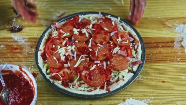 Top view man hands take away baking dish with raw pizza with different ingredients — Stock Video