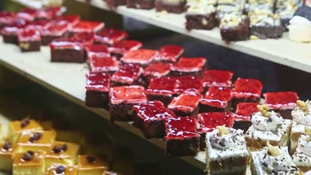 Panorama lent à l'assortiment de différentes pièces de gâteau sucré avec garnitures de fruits — Video