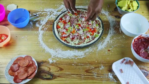 Erkek ellerine üstten bakıldığında yarım kalmış soslu ve peynirli pizzaya soğan parçaları konur. — Stok video