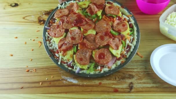 Вид зверху крупним планом на руки людини покласти томатний соус на сиру піцу з пепероні — стокове відео