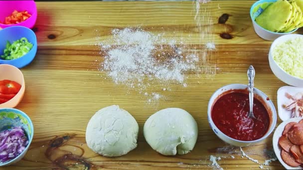 Top view on man by hands making pizza dough big and thin above wooden table — Stock Video