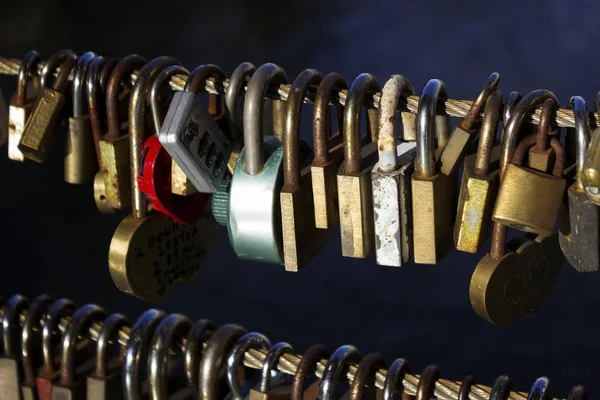 Many locks without keys hang on a bridge in Ljubljana, Slovenia.