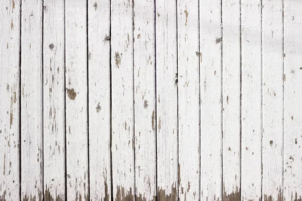 White wood background. Scratched white paint on a wooden plank w