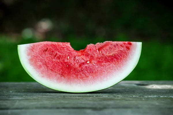 Slice of melon with green background