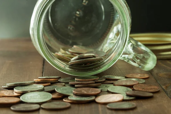 Argent dans un pot en verre sur une table en bois — Photo