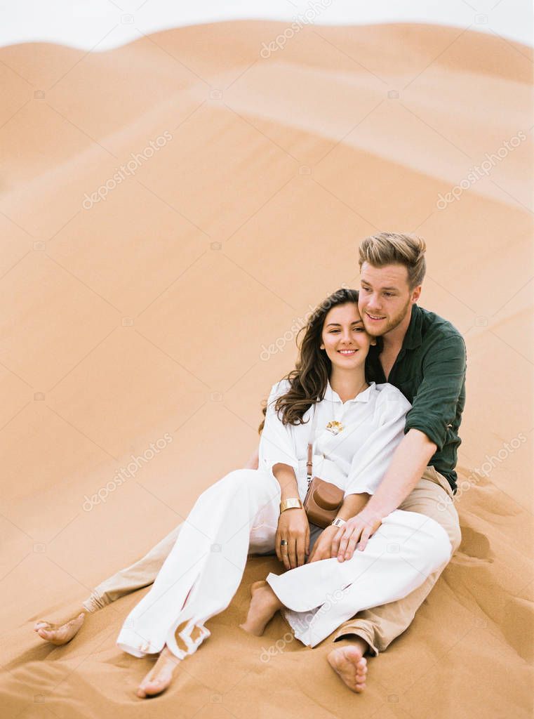 Loving couple in Sahara Desert.