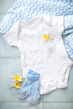 Erkek bebek Bodysuit, Kukla, Çorap ve Bebek Bezi. Hafif arka planda bebek kıyafetleri. 
