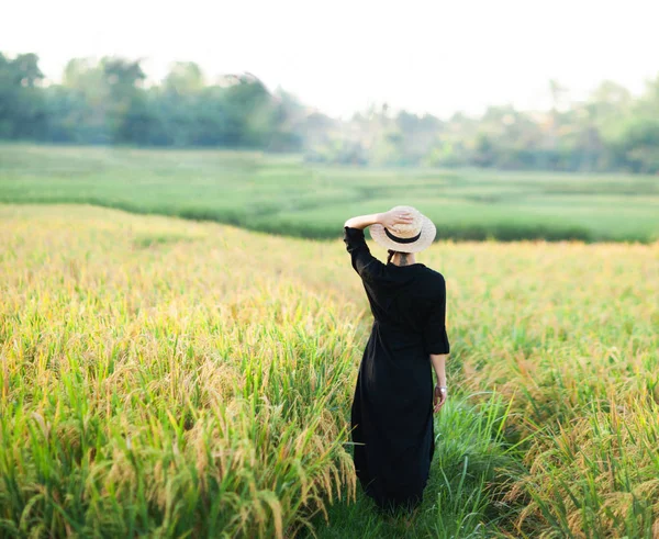 Woman in black dress and straw hat. 로열티 프리 스톡 사진