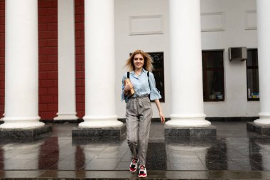 gülümseyen mutlu öğrenci sevgili üniversitesinde yürüyor.