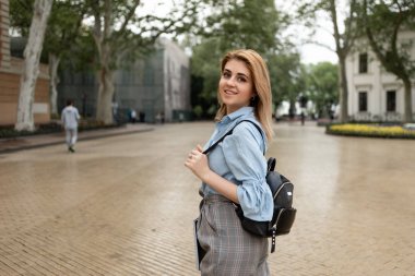 öğrenci bir sırt çantası ile üniversitenin vücut üzerinde yürüyor