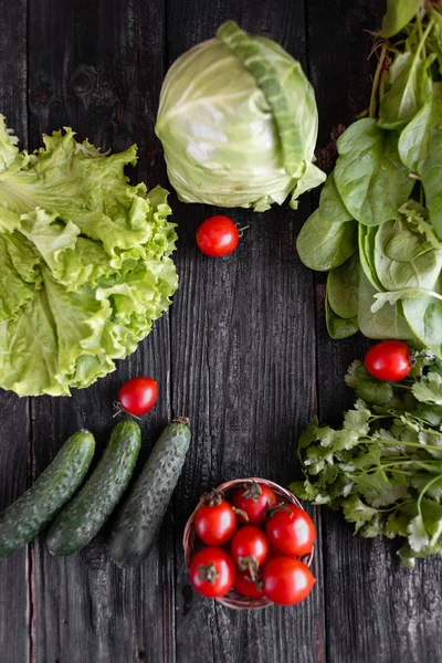 Spices, herbs and fresh vegetables for cooking on a dark wood background with space for text. View from above. — Stock Photo, Image