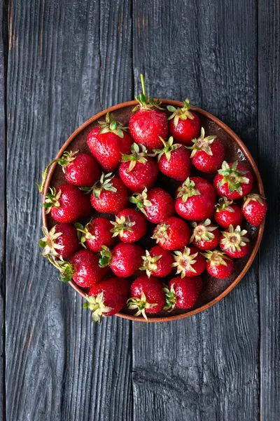 Un montón de fresas maduras y jugosas rojo, plato sobre la mesa. Desayuno vegetariano —  Fotos de Stock