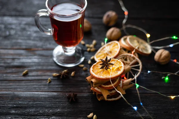 A beautiful piece of anise on a slice of dry orange, a table made of wood, a place under the text — Stock Photo, Image