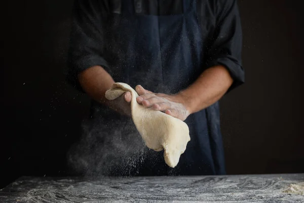 male chef hands toss pizza cake, cooking concept