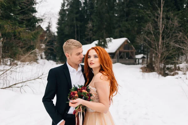 Organisation av ett bröllop på vintern, bruden och brudgummen ömt krama varandra medan stående på gatan. — Stockfoto