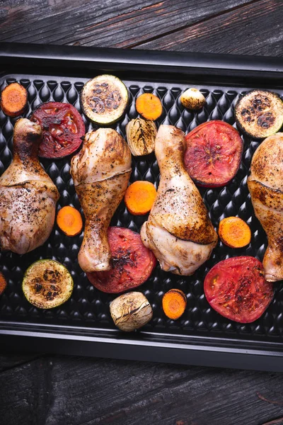 Delicious and fragrant chicken legs, grilled, vegetables and meat — Stock Photo, Image