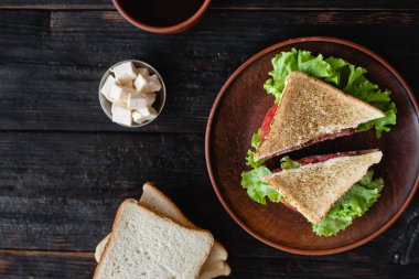Tabakta iki dilim sandviç, tüm aile için lezzetli bir kahvaltı.,