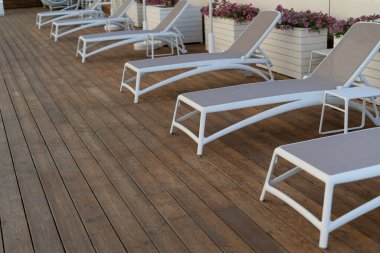 Kaplıca ya da havuz kenarındaki kahverengi şilteli güneş şezlonglarının yakın görüntüsü. Havuz tatili ve rahatlama kavramı.