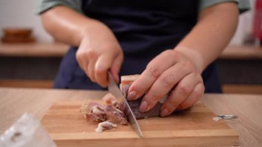 Chefs hands cut lard on cutting board before preparing a delicious food for dinner at home. Fat food concept.