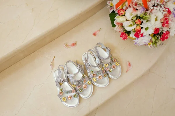 Two pairs of cute sandals for twin girls on marble floor — Stock Photo, Image