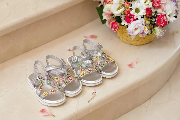 Two pairs of cute sandals for twin girls on marble floor — Stock Photo, Image