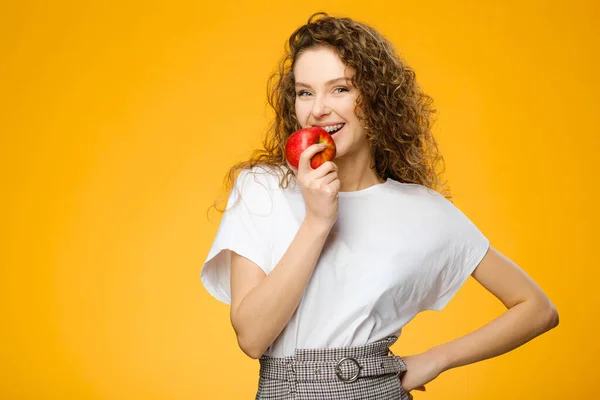 Portrait Pretty Caucasian Girl Curly Hair Bites Apple Isolated Colorful — Stock Photo, Image